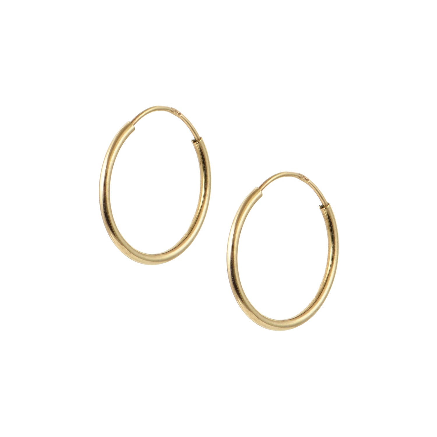 Pair of 14K gold hoop earrings with tube closure on white background