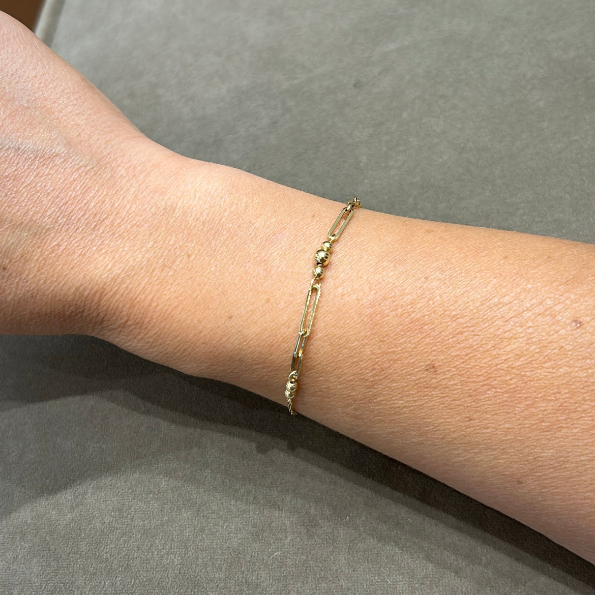 Close-up of 9K gold bracelet showing fixed bead detail and lobster clasp