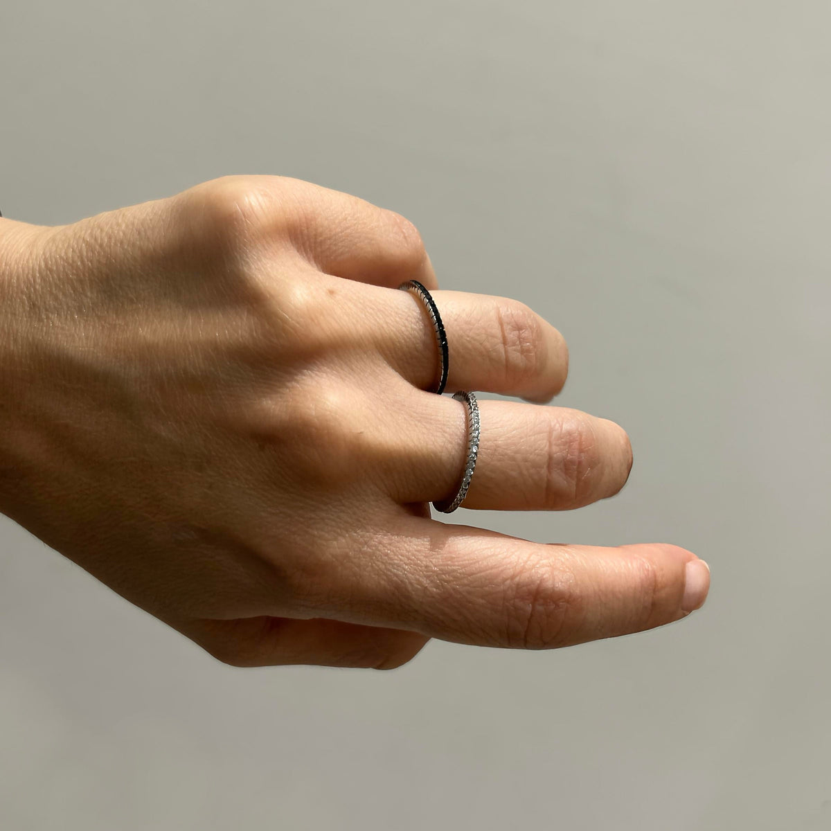 Raised band ring worn on hand, showing raised zirconia detail